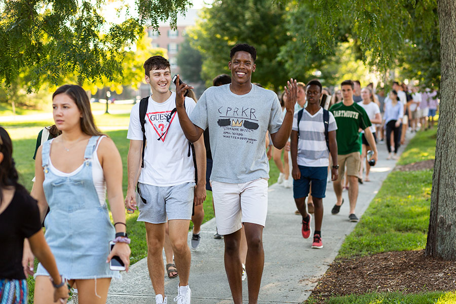 Students walk along a sidewalk in Hanover